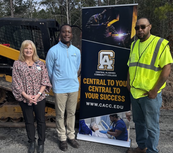 Central Alabama Community College members standing beside signage