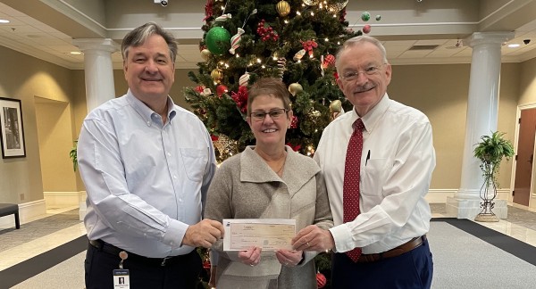 Central Alabama Community College members holding donantion check